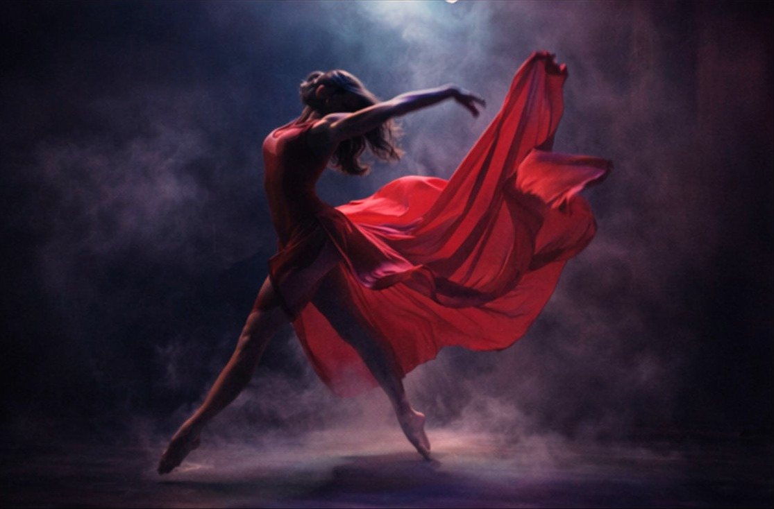 Dancer with flowing red fabric in the studio